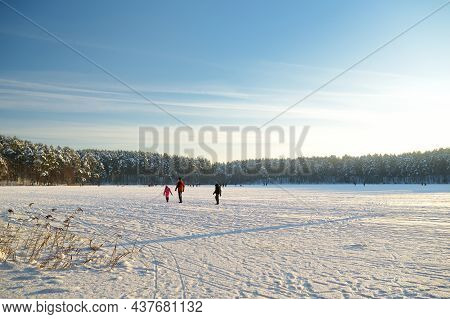 Beautiful View Of Ice Covered Balzis Lake. Snowy Pine Forests Surrounding A Small Lake. Winter Lands