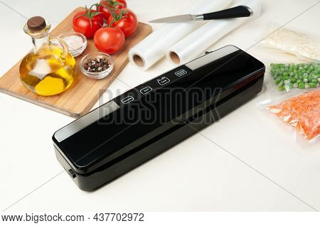 Vacuum Packing Machine. For Long-term Storage Of Food. Nearby Packed Products. Top View Light Backgr