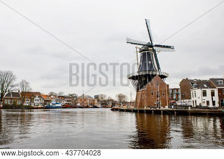 Cityscape Of Haarlem, The Netherlands. View Of Old Windmill And Typical Dutch Houses.