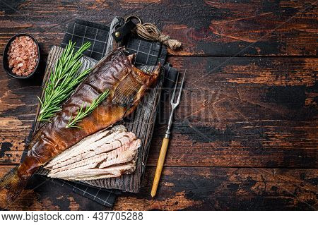 Cut Hot Smoked Fish On A Wooden Board With Rosemary. Dark Wooden Background. Top View. Copy Space