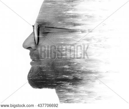 A portrait of an attractive man combined with digital art in a double exposure technique.
