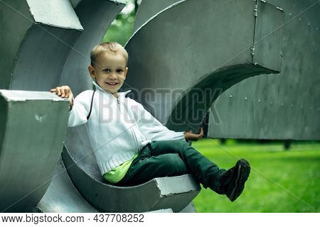 Portrait of a boy sitting on the playground.