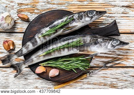 Raw Whole Icefish With Herbs. White Wooden Background. Top View