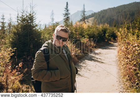 Young Man With Backpack See View On Top Mountain. Freedom, Happiness, Travel And Vacations Concept, 