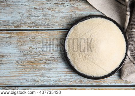 Plate With Gelatin Powder On Light Blue Wooden Table, Top View. Space For Text