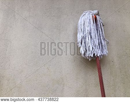 Classic Mop With Cotton Head On Wall