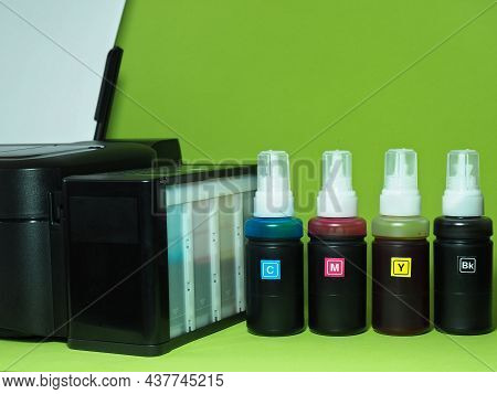 Printer And Printer Ink Color Bottles. Economical Printing. Easy Ink Color Refilling