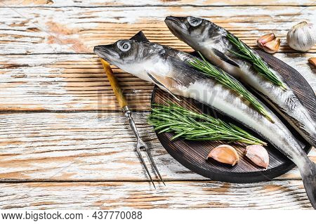 Raw Whole Icefish With Herbs. White Wooden Background. Top View. Copy Space