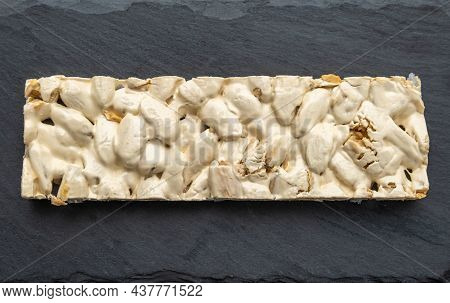 Top View Of Christmas Turron Over Black Background.