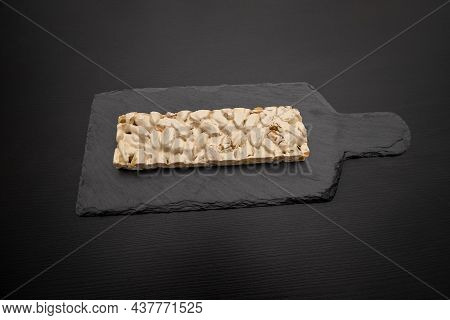 Top View Of Christmas Turron Over Black Background.
