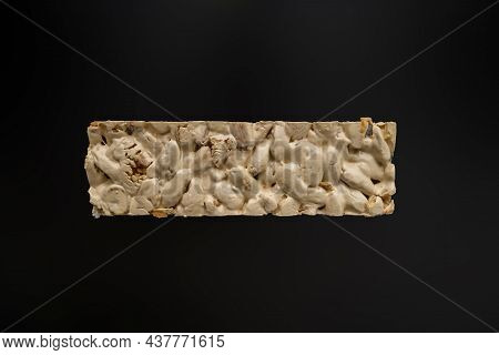 Top View Of Christmas Turron Over Black Background.