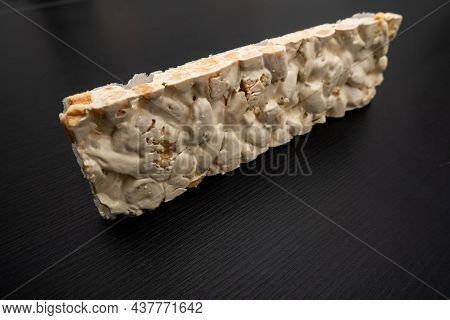 Perspective View Of Christmas Turron Over Black Background.