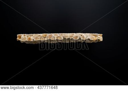 Side View Of Christmas Turron Over Black Background.