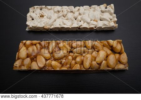 Top View Of 2 Different Types Of Spanish Turrons On Black Background