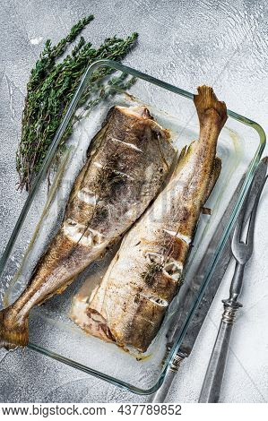 Fish Dish - Roasted Cod Fish With Herbs In Baking Dish. White Background. Top View