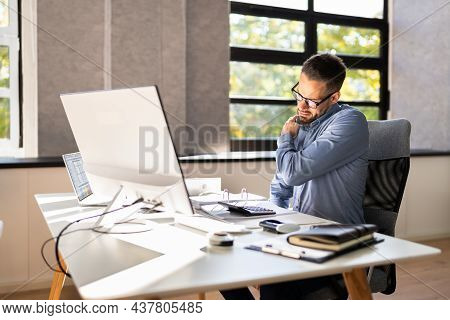 Shoulder Pain And Posture. Man Suffering Near Workstation Computer