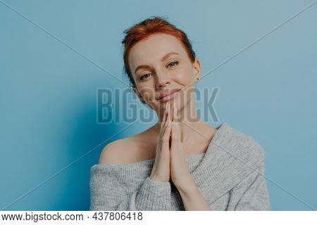 Calm Beautiful Young Woman With Red Hair In Bun Making Wish With Palms Pressed, Praying God, Asking 