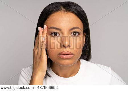 Stressed Woman Looking At Face Wrinkles Of Aging Skin And Crows Feet Around Eye. Closeup Of Young Af