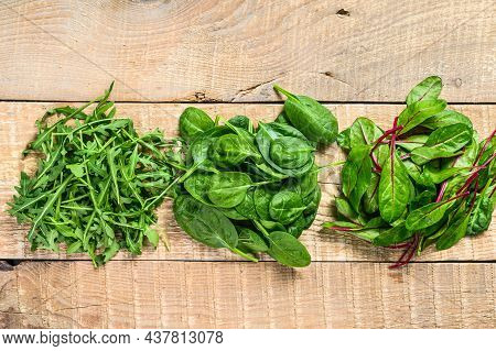 Mix Salad Leafs, Arugula, Spinach And Swiis Chard. Wooden Background. Top View