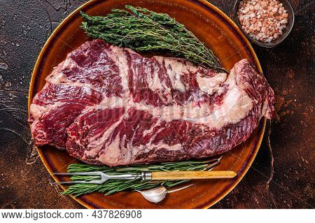 Raw Hanging Tender Or Ongle Beef Meat Steak On Rustic Plate With Herbs. Dark Background. Top View