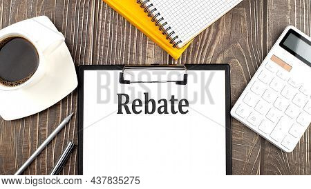 Rebate Text On Paper With Coffee, Calculator And Notebook. Business