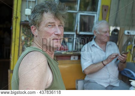An Adult Son On The Background Of An Elderly Old Man's Father. Father And Son.