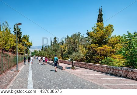 Athens, Greece - July 11 2021: Incidental People On Apostolou Pavlou St, The Pedestrian Zone That Go