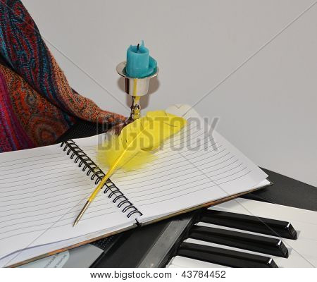 Still Life With A Notebook And A Feather On A Synthesizer
