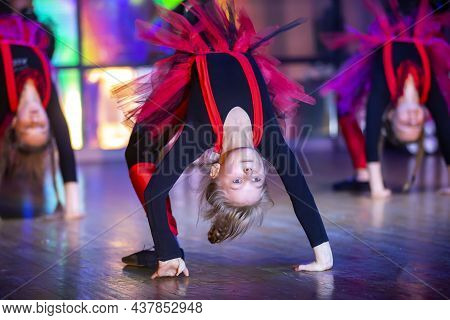 Little Girls Perform A Dance Number. Dance For Helovinna In Red Costumes.little Girl Dancing