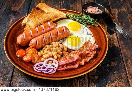 Traditional Full English Breakfastt With Fried Eggs, Sausages, Bacon, Beans And Toasts. Dark Wooden 