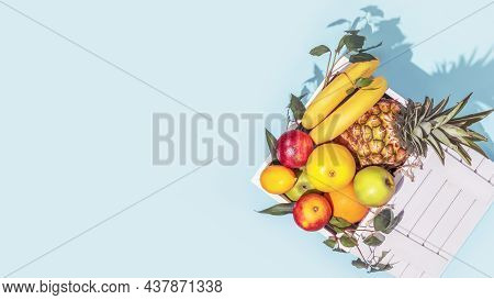 Card With Fresh Tropical Fruits In A White Wooden Box With Dark Shadow On A Blue Background With Cop