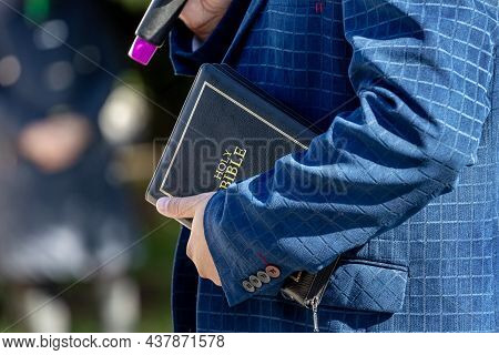 Pastor With A Bible In His Hand During A Sermon. The Preacher Delivers A Speech
