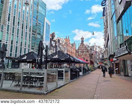 Amsterdam, The Netherlands - 04 October, 2021: People Walking In The Nieuwezijds Voorburgwal Street.