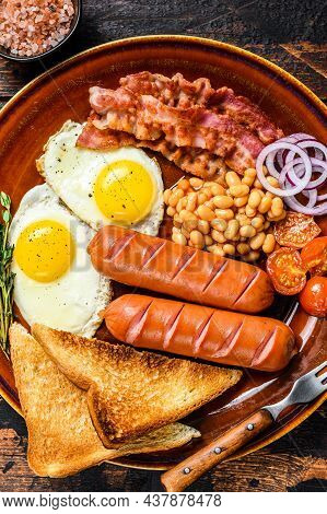 Traditional Full English Breakfastt With Fried Eggs, Sausages, Bacon, Beans And Toasts. Dark Wooden 