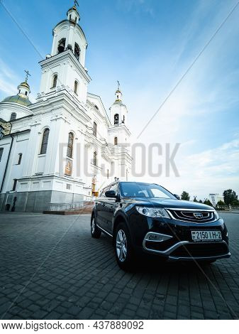 Vitebsk, Belarus - August 2021: Geely Atlas In Black On The Square In Front Of The Holy Dormition Ca