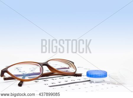 Contact Lenses Case And Eye Glasses On And Eye Test Chart. Vision Concept. Way To Improve Vision. Cl