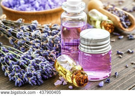 Lavender's Spa Products With Dried Lavender Flowers On A Wooden Table. Flat Lay Bath Salt And Massag