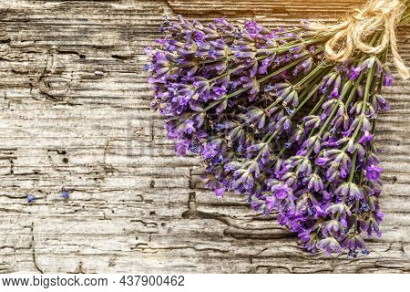 Lavender's Spa Products With Dried Lavender Flowers On A Wooden Table. Flat Lay Bath Salt And Massag