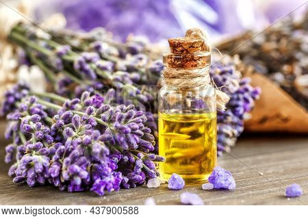 Lavender's Spa Products With Dried Lavender Flowers On A Wooden Table. Flat Lay Bath Salt And Massag