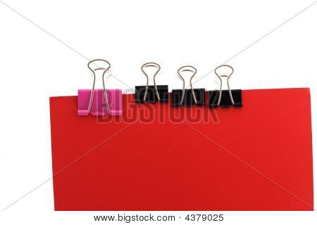 Paper Clips On A Red Background