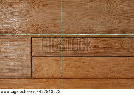 Cross Lines Of Laser Level On Wooden Wall