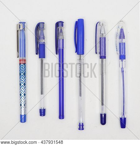 Horizontal Shot Of A Group Of Different Types Of Blue Pens Arranged Parallel To Each Other Isolated 