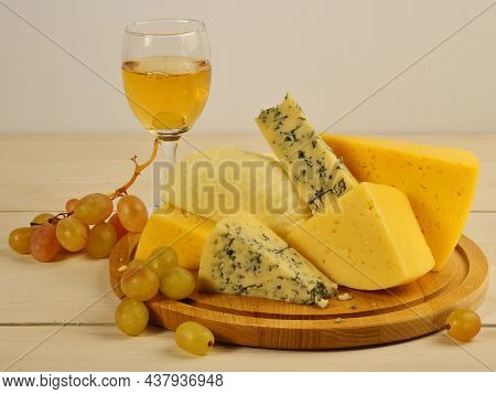 Cheese Platter. Cheese Dor-blue, Lambert, Maasdam, Suluguni, Dutch. Cheese Slicing. A Glass Of Wine,