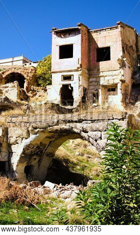 Ancient Ruins Of Houses Against Blue Sky. Abandoned Old Cave Houses. Town Of Avanos Is Set On Banks 