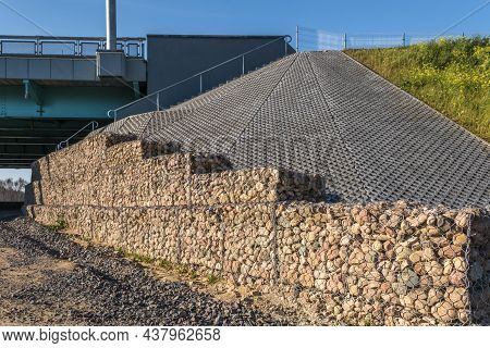 Engineering Structure Made Of Stones Behind Metal Wire Netting To Strengthen The River Bank Near The