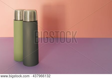 Two Thermos - Green And Gray On A Peach-fiolet Background