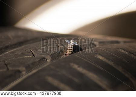 Punctured Car Wheel. Puncture Of Car Wheel, Steel Screw Is In Tyre, Close-up View