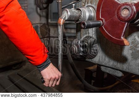 The Hand Of A Man Worker Holds And Controls The Handle Of A Milling Mill Close-up In An Industrial E