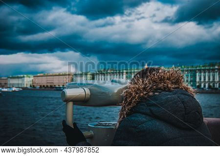 Girl Looks In Binoscope On City. St. Petersburg Architecture