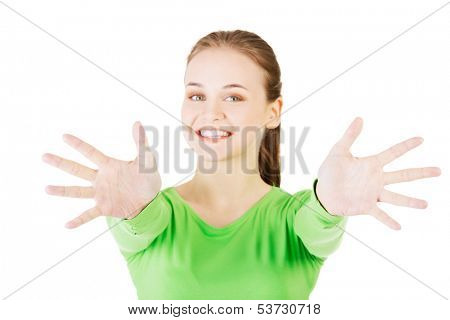 Attractive  woman with hands open in front oh her. Isolated on white. 